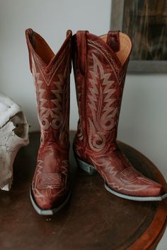 The Old Gringo Nevada Boot is the perfect pair of red cowgirl boots. The Nevada Boots were handcrafted in Leon, Mexico by expert boot makers. We love the white embroidery against the distressed red leather. Every girl needs a pair of red cowgirl boots, and the Nevada is an excellent choice. Old Gringo Boots are instantly comfortable and always stylish. It's time to cut footloose in the Nevada Red Cowgirl Boots by Old Gringo! Measurements: Shaft Height - 13" Shaft Opening - 13.5" circum. Heel Hei Cowgirl Boots Red, Vintage Red Cowgirl Boots, Luxury Red Western Cowboy Boots, Red Western Knee-high Boots, Harness Boots