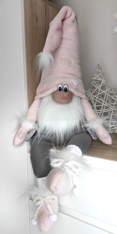 a stuffed toy gnome sitting on top of a shelf