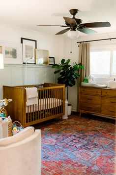 a baby's room with a crib and dresser