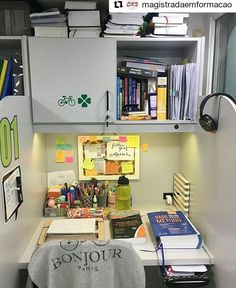 an office cubicle with lots of books and papers