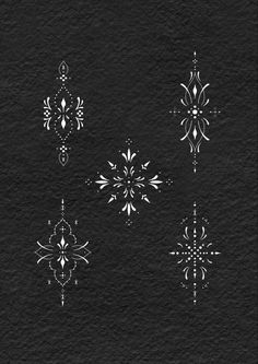 six white snowflakes on black paper