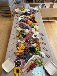 a long table covered with different types of food and snacks on it's sides