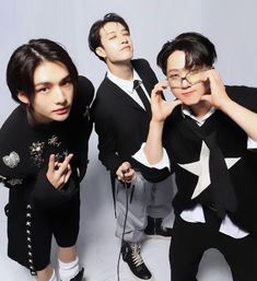 three young men in black and white outfits