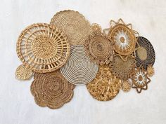 many woven objects are arranged on a white surface