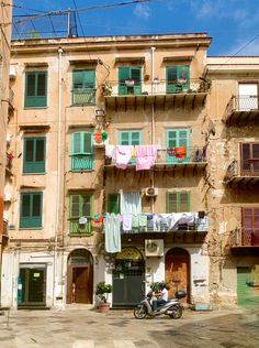 an apartment building with clothes hanging out to dry