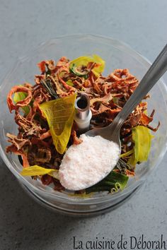 a bowl filled with lots of different types of food and a spoon next to it