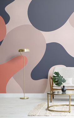 a living room scene with a couch, chair and wallpaper that has an abstract design on it