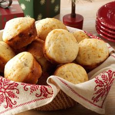 a basket filled with muffins sitting on top of a table next to christmas presents