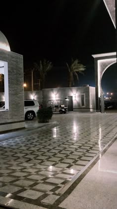 a white car parked in front of a building with lights on it's side