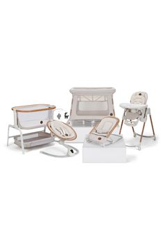 an assortment of baby furniture including a high chair, crib and changing table