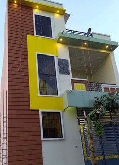 a tall multi - colored building with lights on the top and below it's windows