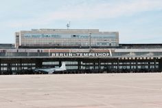 an airplane is parked in front of the berlin - tempelhorn airport terminal