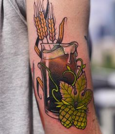 a tattoo on the arm of a man with a glass of beer and ears of wheat