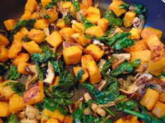 a pan filled with vegetables and meat on top of a stove