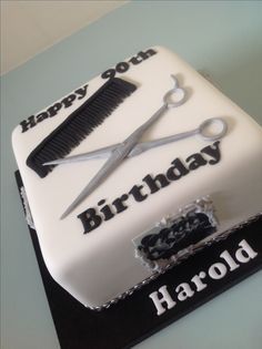 a birthday cake with scissors and combs on it