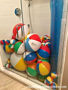 a shower filled with lots of colorful beach balls