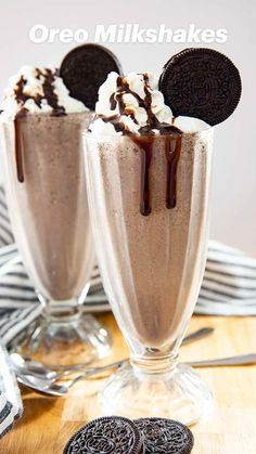 two glasses filled with ice cream and oreo cookies sitting on top of a table