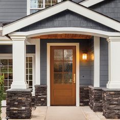 the front door of a house with stone pillars