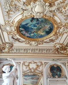 an ornately decorated room with paintings on the ceiling