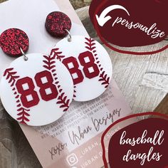 the baseball earrings are decorated with red glitter