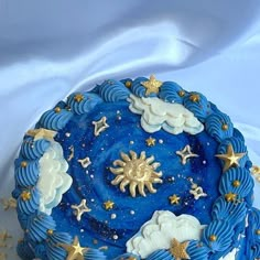 a blue cake with stars and clouds on it