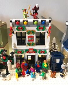 a lego building with many different toys on it's front and back sides, including figurines