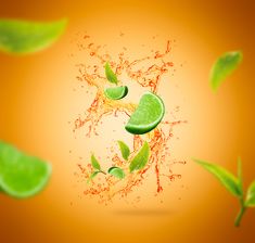 an orange background with limes and water splashing on it's surface in the air