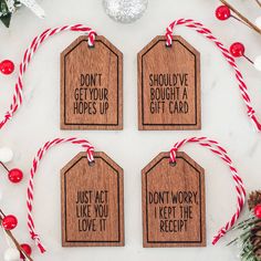 four wooden tags that say don't get your hopes up, just act like you love it