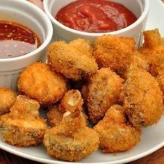 fried food on a plate with dipping sauces