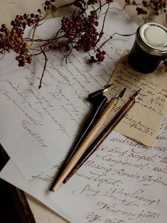 an old letter with writing on it next to a pen and inkwell