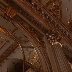 an ornate ceiling with gold decorations and chandeliers