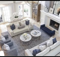 an aerial view of a living room with couches, chairs and fireplace in it