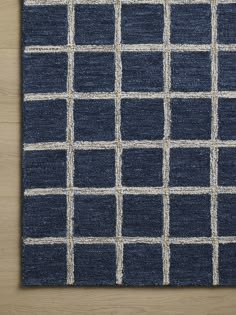 a blue rug with white squares on it