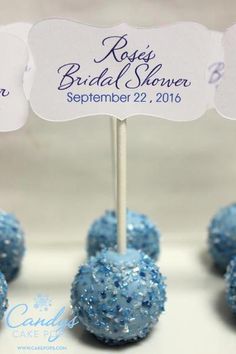 some blue cake pops are sitting on a table