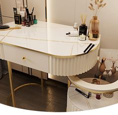 a white desk with gold trim and some bottles on it next to a mirror in a room