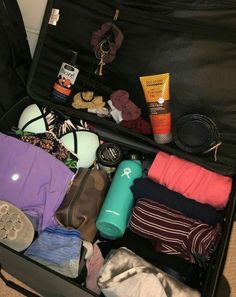 an open suitcase filled with clothes and other items