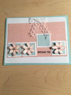 a close up of a greeting card with flowers on the front and bottom, along with an envelope that says missing you