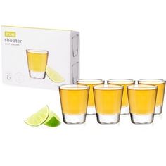 five shot glasses with lime slices and a box