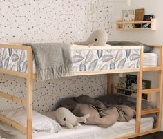 a wooden bunk bed sitting in a bedroom next to a white rug