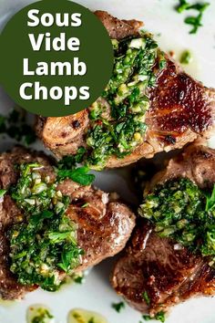 some lamb chops on a white plate with green garnish