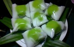 some food is on a white plate with green onions and celery in it