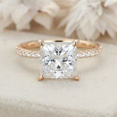 a princess cut diamond ring with pave set shoulders