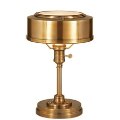 an antique brass table lamp on a white background