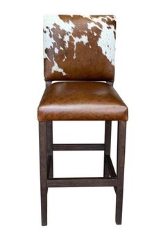 a brown and white cowhide bar stool