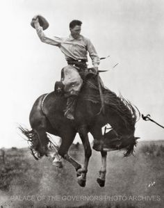 a man riding on the back of a horse with a hat in it's hand