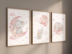 three elephants are hanging on the wall with pink flowers and balloons in front of them