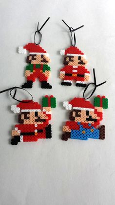 four christmas ornaments made out of legos