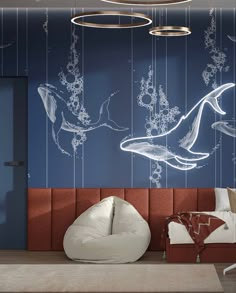 an artisticly designed bedroom with blue and white wallpaper, two whales hanging from the ceiling