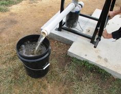 a black bucket with water coming out of it and the words diy expensive small diamer water well