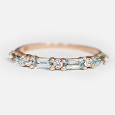 an image of a diamond and aquamarine blue stone band ring on white background with copy space